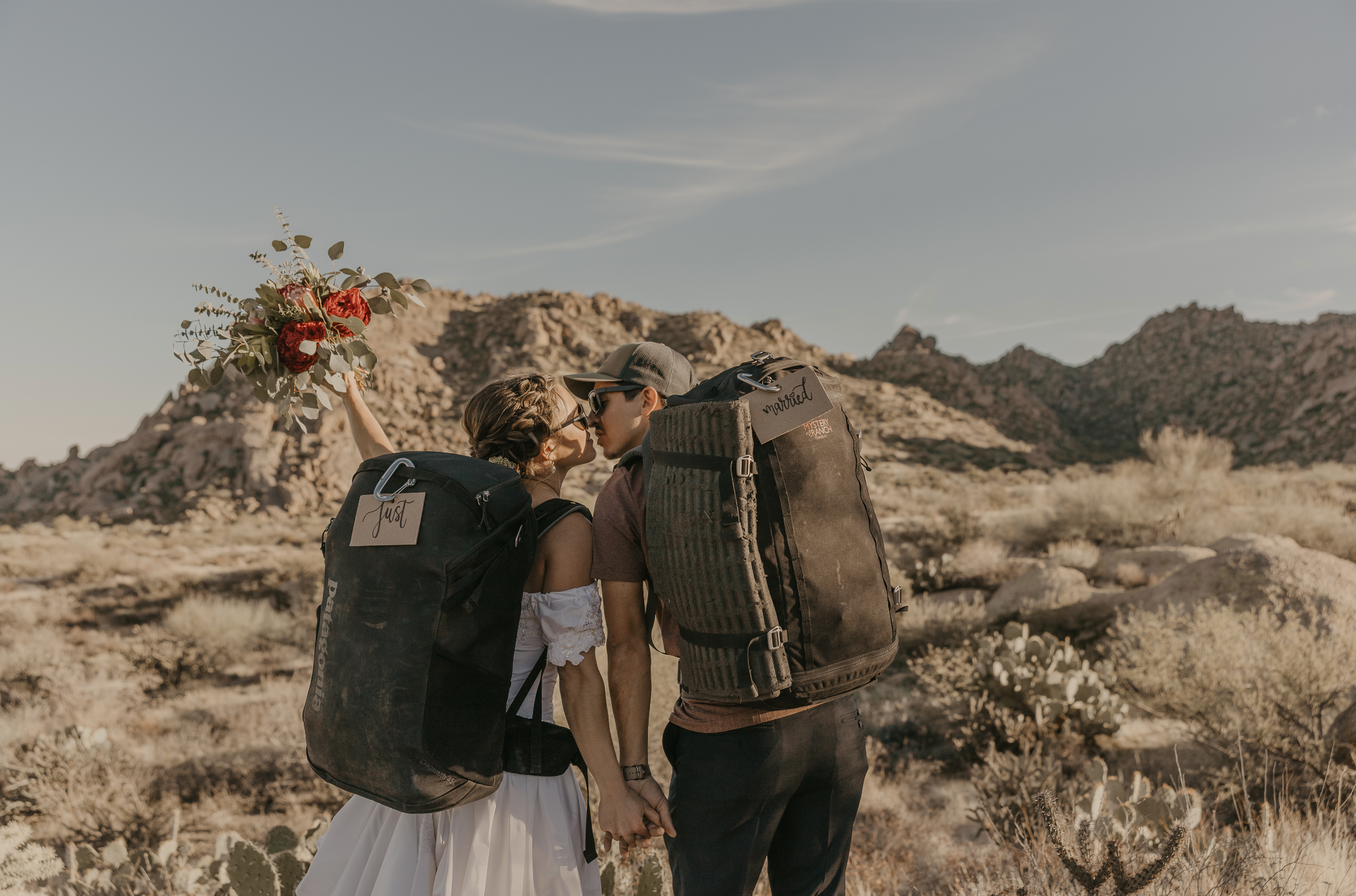 Bride and groom holding their flowers at their rock climbing elopement