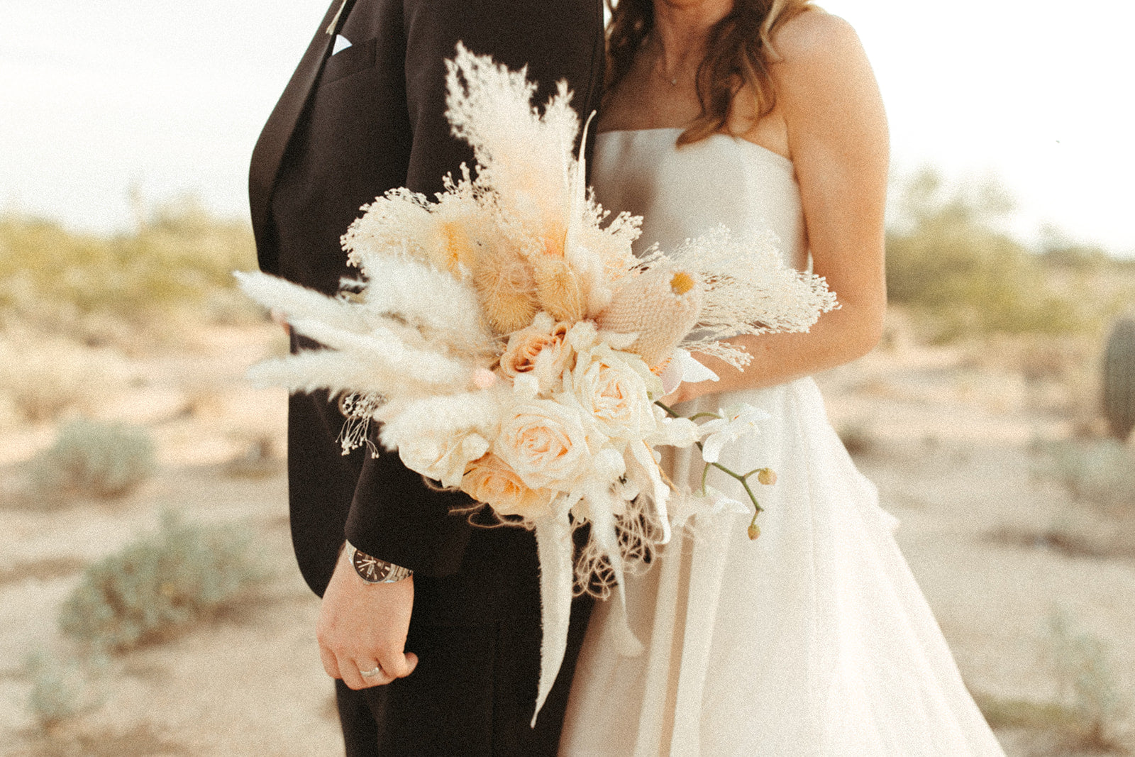 Bride and groom holding bouquet of dried and fresh wedding flowers in North Scottsdale, Arizona