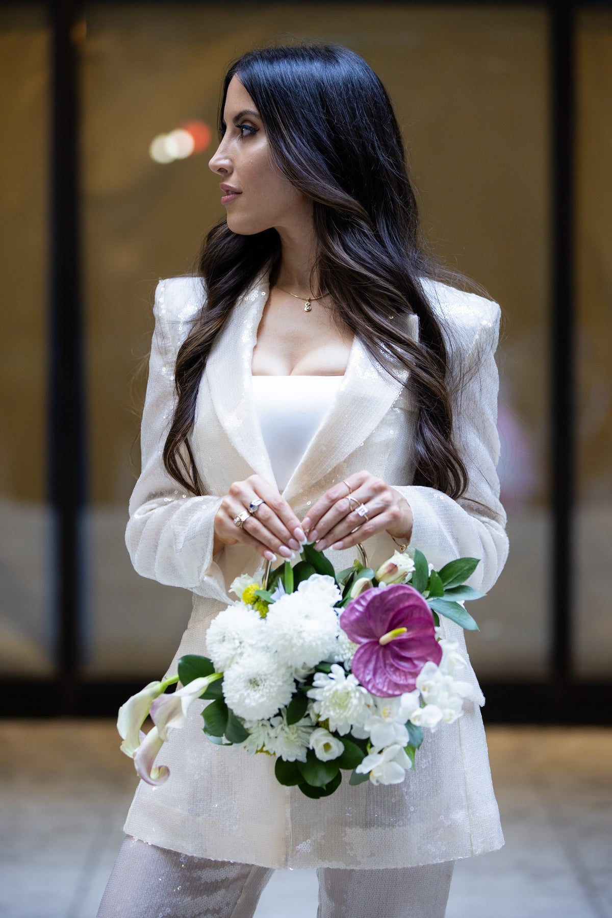 Bride in suit carrying flower purse