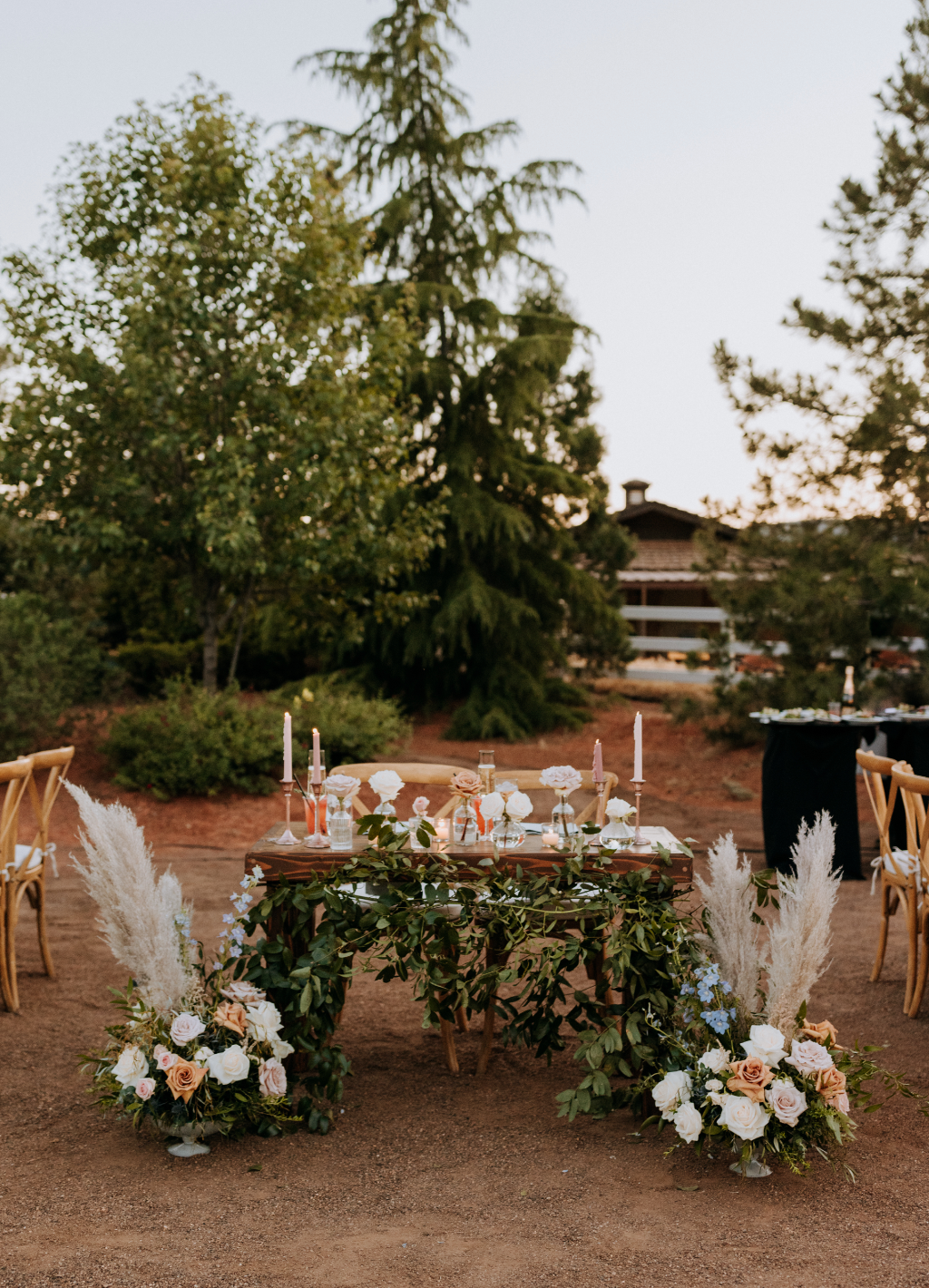 Sweetheart table florals set up before the reception in a desert setting