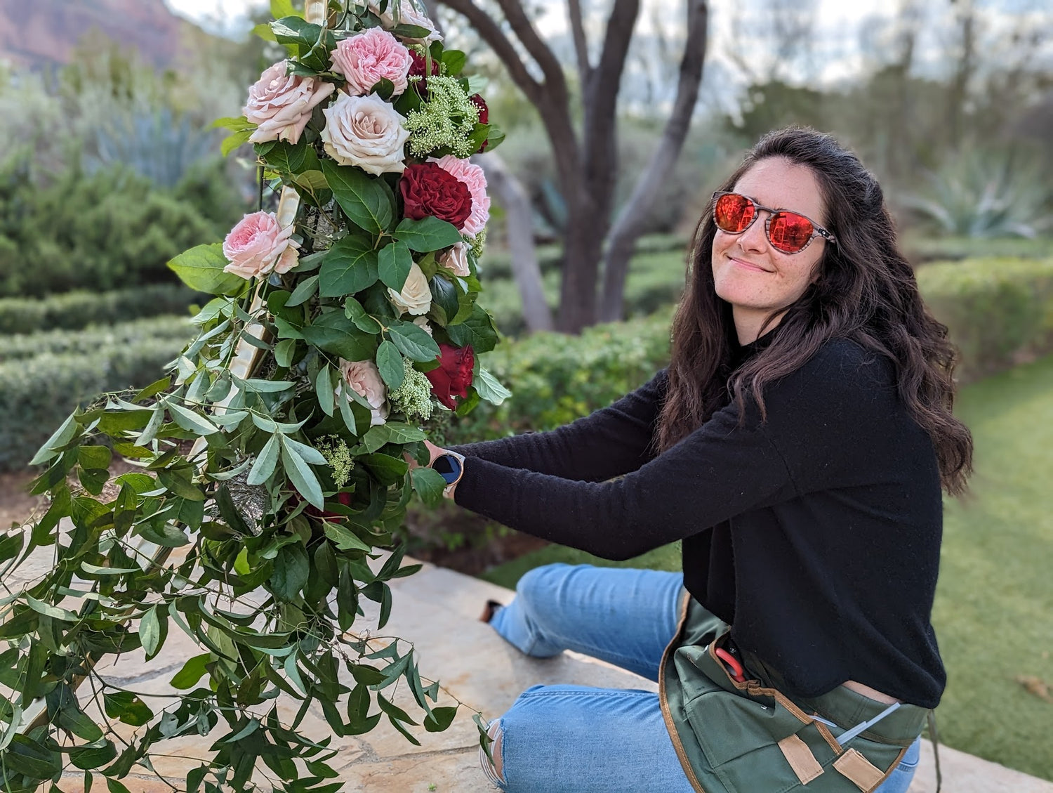 Florist building ceremony arch installation for a wedding at El Chorro in Phoenix, AZ