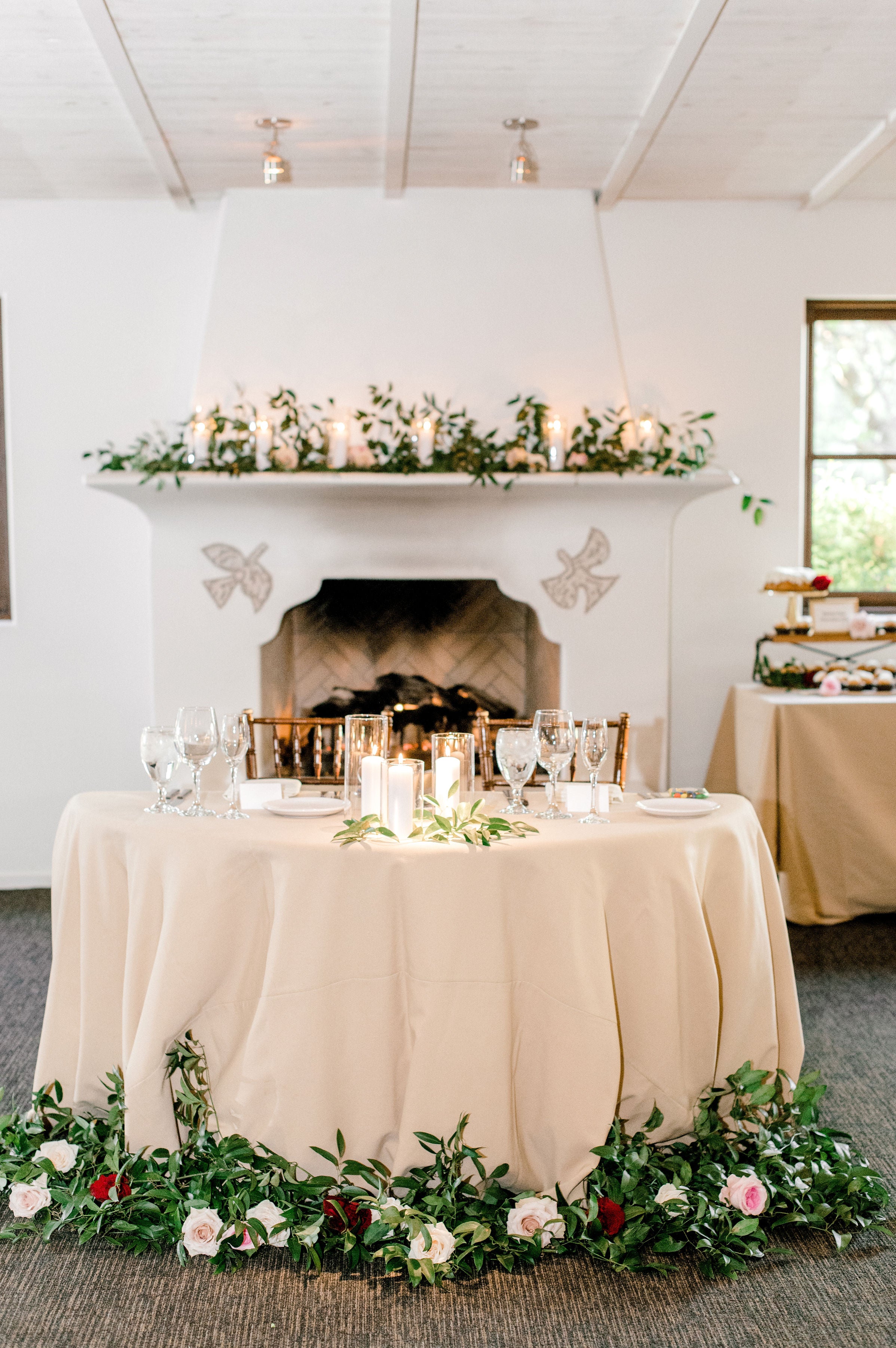 Sweetheart table flowers set up in front of El Chorro's iconic fireplace